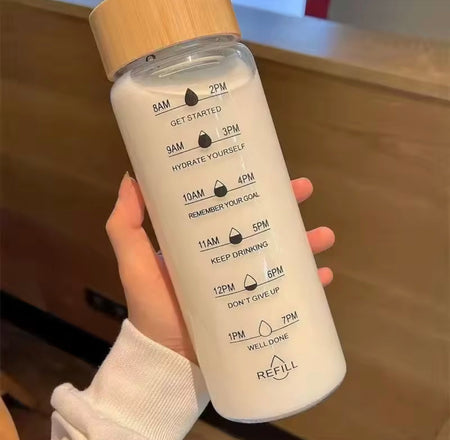 transparent glass water bottle with wooden lid image 4