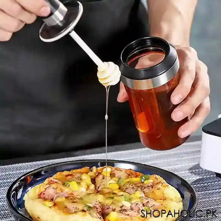 glass storage jar with honey stick image2